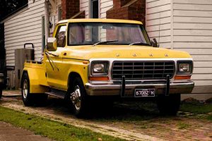A yellow classic Ford pickup
